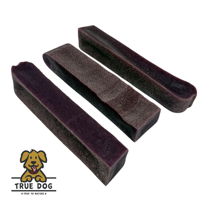 Three True Dog Yak Chews Blueberry Flavour in a row, on a white background. Yak Milk dental chew bars for dogs.