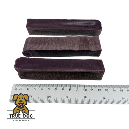 Three True Dog Yak Chews next to a ruler to show a rough length of 12cm.
