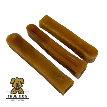 Three True Dog Yak Chews Peanut Butter Flavour in a row, on a white background. Yak Milk dental chew bars for dogs.