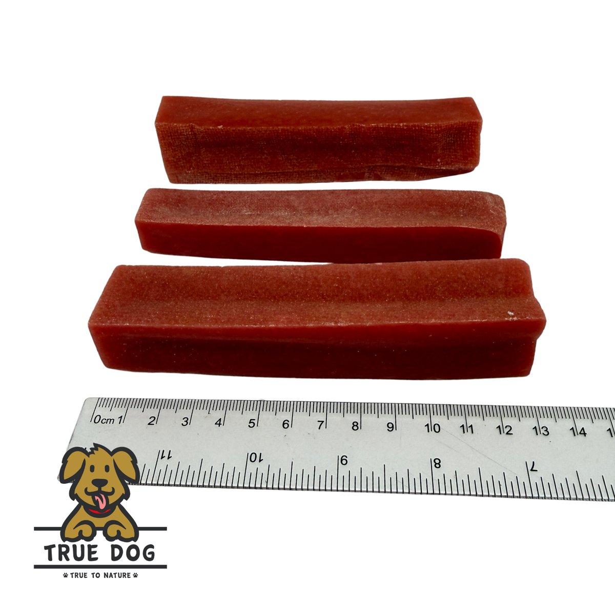 Three True Dog Watermelon Yak Chews next to a ruler to show a rough length of 13cm. 